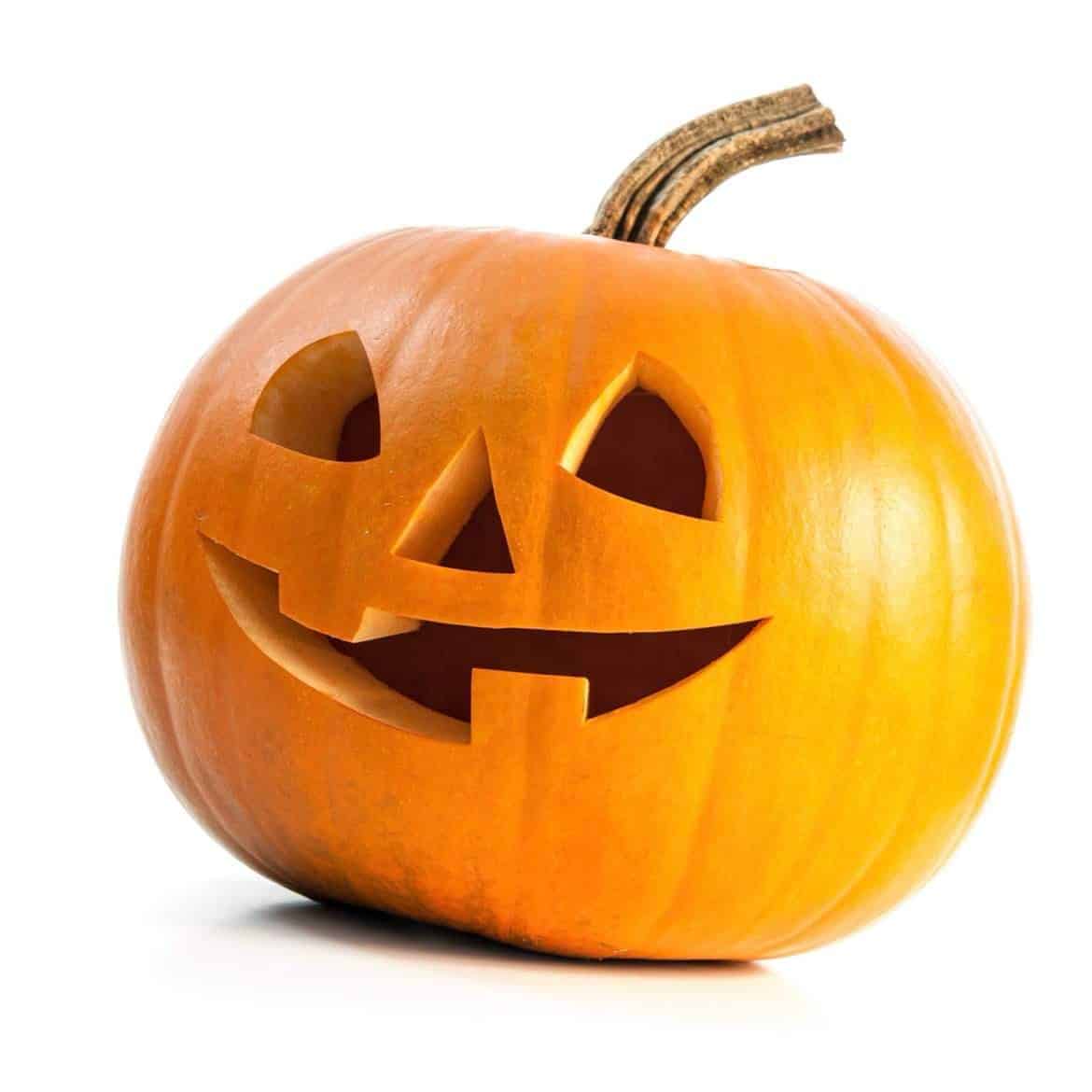 A carved pumpkin with a smiling face, typically associated with Halloween.