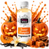 A bottle of Fizzy Whiz Sweet Pumpkin Fragrance Oil centered on a white background, surrounded by decorative Halloween-themed props including carved pumpkins, sliced pumpkin, vanilla beans, cinnamon sticks, and caramel cubes. Orange liquid splashes rise behind the bottle.