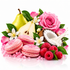 A styled still life of pink macarons, pink raspberries, a green pear, white flowers, a pink rose, a coconut shell, and pink crystal-like beads on a white background.