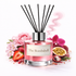 Pink diffuser bottle labeled 'The Bombshell' with floral and fruit elements on a white background