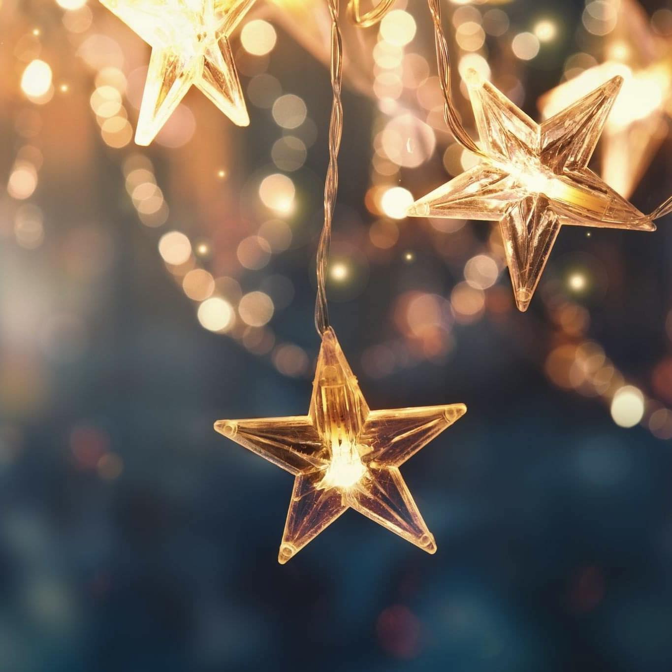 String lights with star-shaped bulbs against a blurred background with bokeh effect