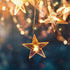 String lights with star-shaped bulbs against a blurred background with bokeh effect