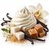 A styled food product shot featuring a swirl of whipped cream, vanilla beans, brown sugar, caramel cubes, and white orchid flowers on a clean white background.