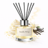 Reed diffuser labeled 'Vanilla Whip' with vanilla beans and flowers on a white background