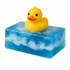 Yellow rubber duck on a bar of blue soap with wave patterns