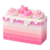 Pink and white layered soap with decorative elements on a white background