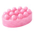 Pink soap with embedded pink beads on a white background