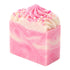 Pink and white swirled soap bar with decorative beads on a white background